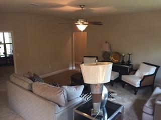 3636 Ranch Drive Crestview, FL 32539 - Photo 5 of 26 a living room with a couch and a chandelier