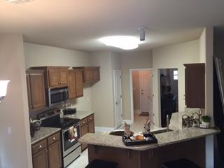 3636 Ranch Drive Crestview, FL 32539 - Photo 7 of 26 a kitchen with kitchen island granite countertop a sink appliances and cabinets