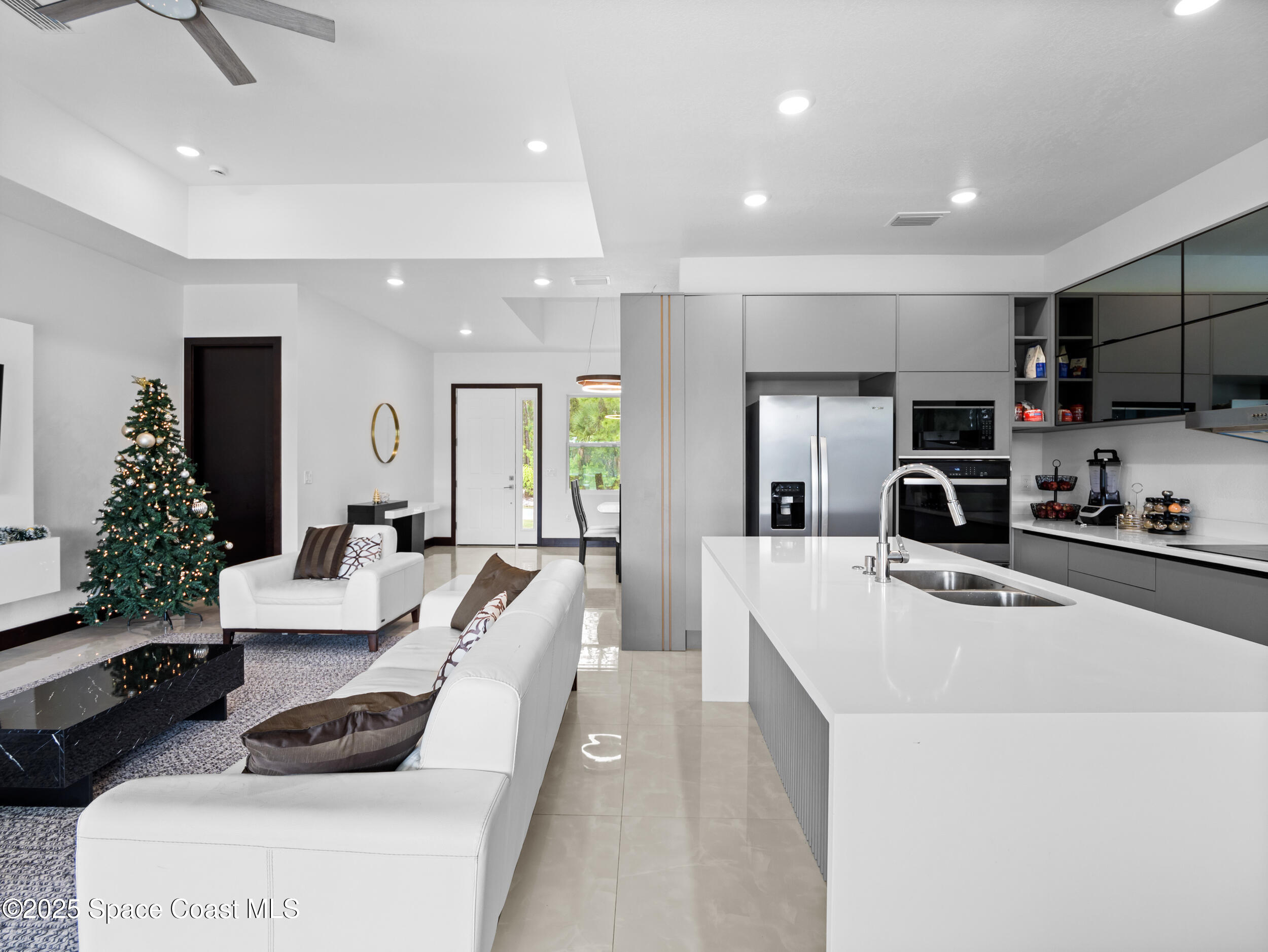 434 Flagler Road Southeast Palm Bay, FL 32909 - Photo 13 of 36 a large white kitchen with lots of counter space a sink a refrigerator and a cabinets