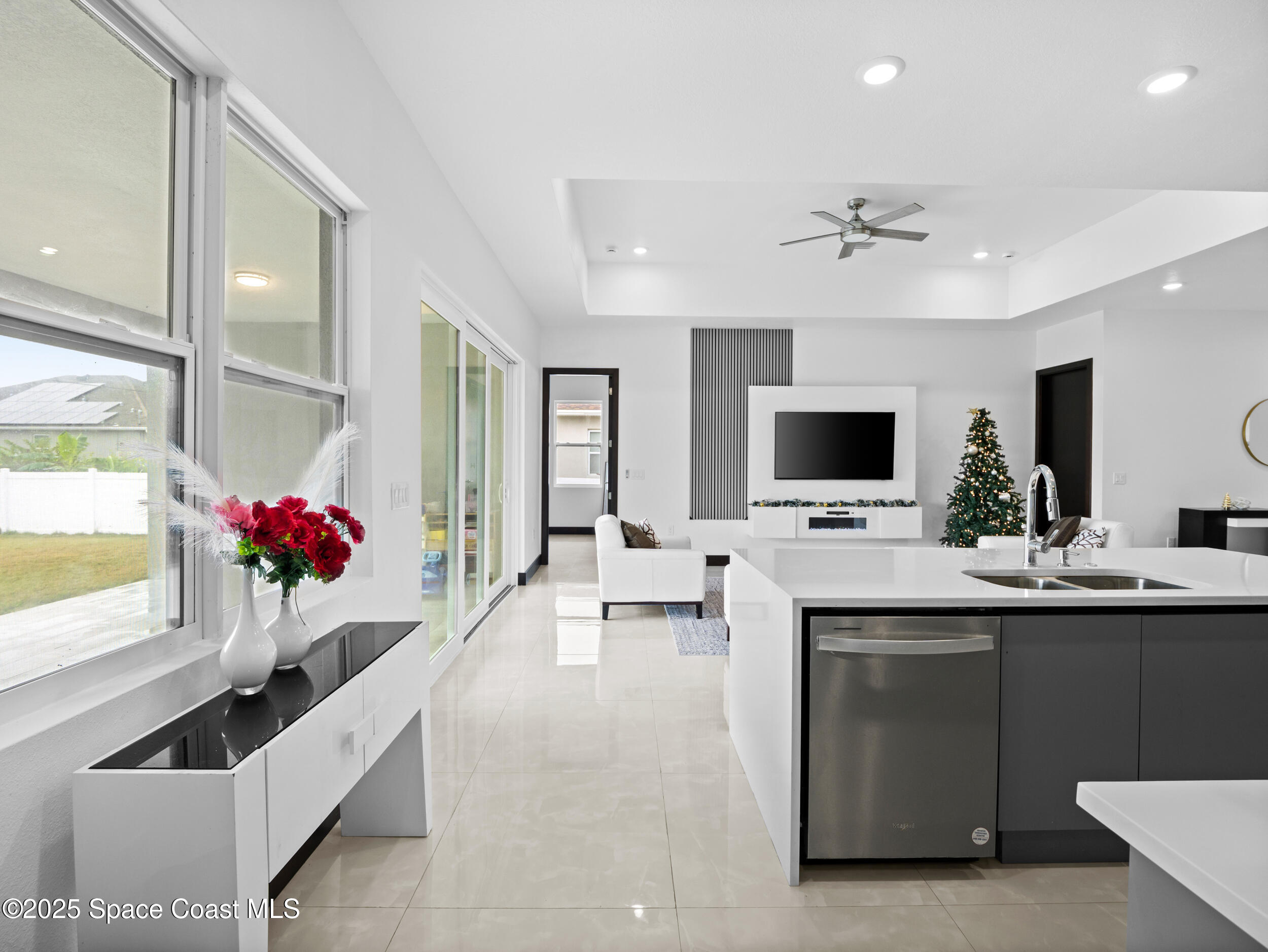 434 Flagler Road Southeast Palm Bay, FL 32909 - Photo 16 of 36 a living room with kitchen island furniture and a flat screen tv