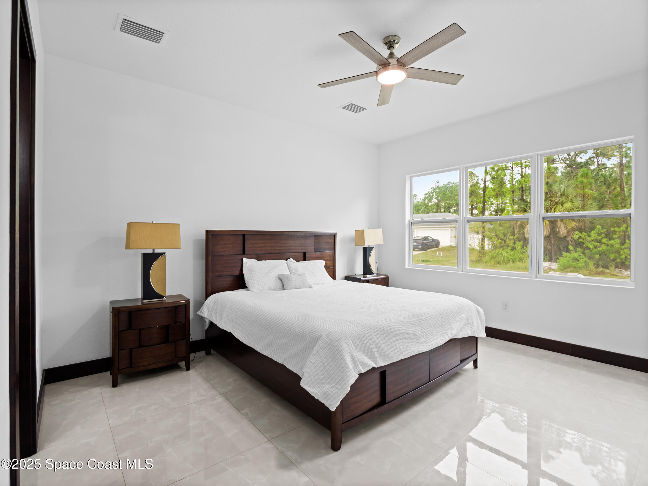 434 Flagler Road Southeast Palm Bay, FL 32909 - Photo 23 of 36 a bedroom with a bed and window