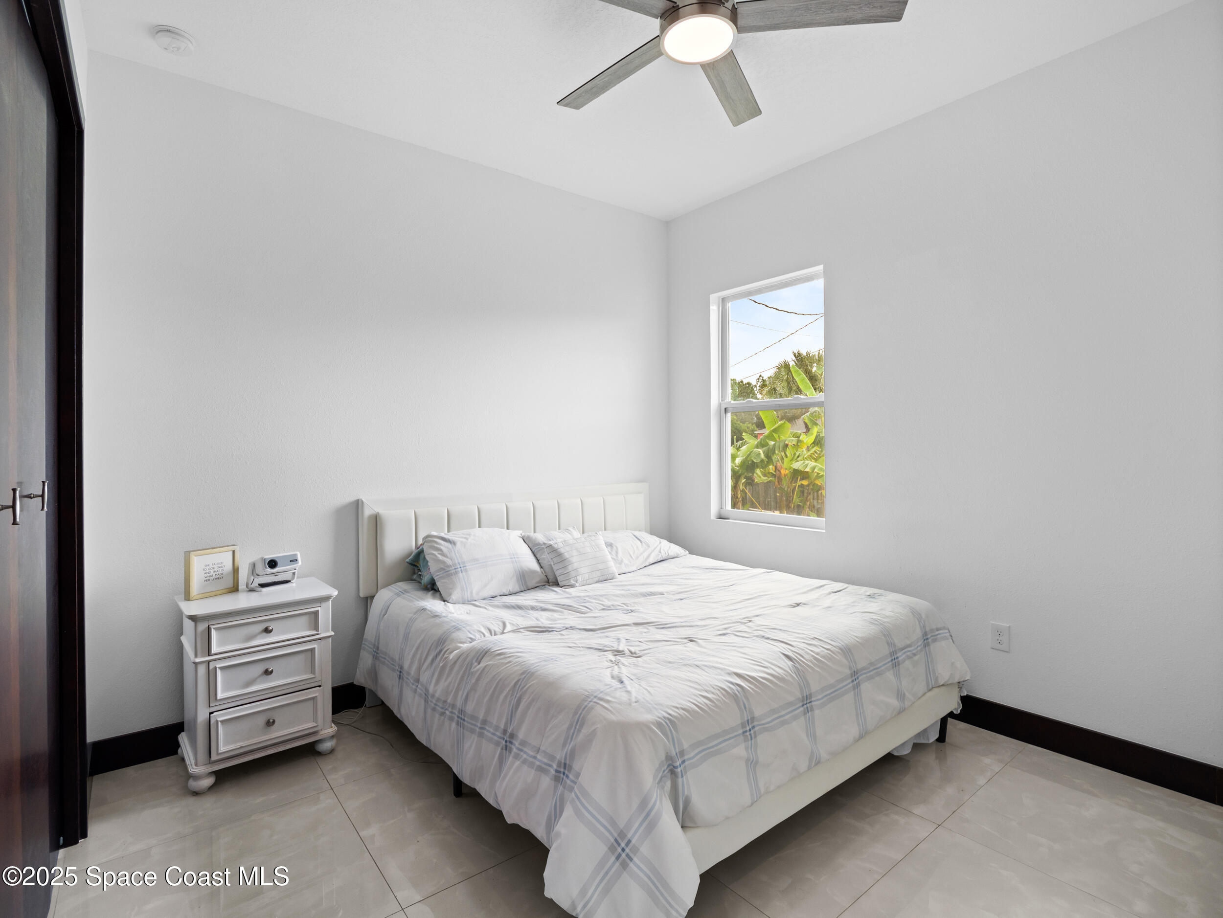 434 Flagler Road Southeast Palm Bay, FL 32909 - Photo 24 of 36 a bedroom with a bed and a window
