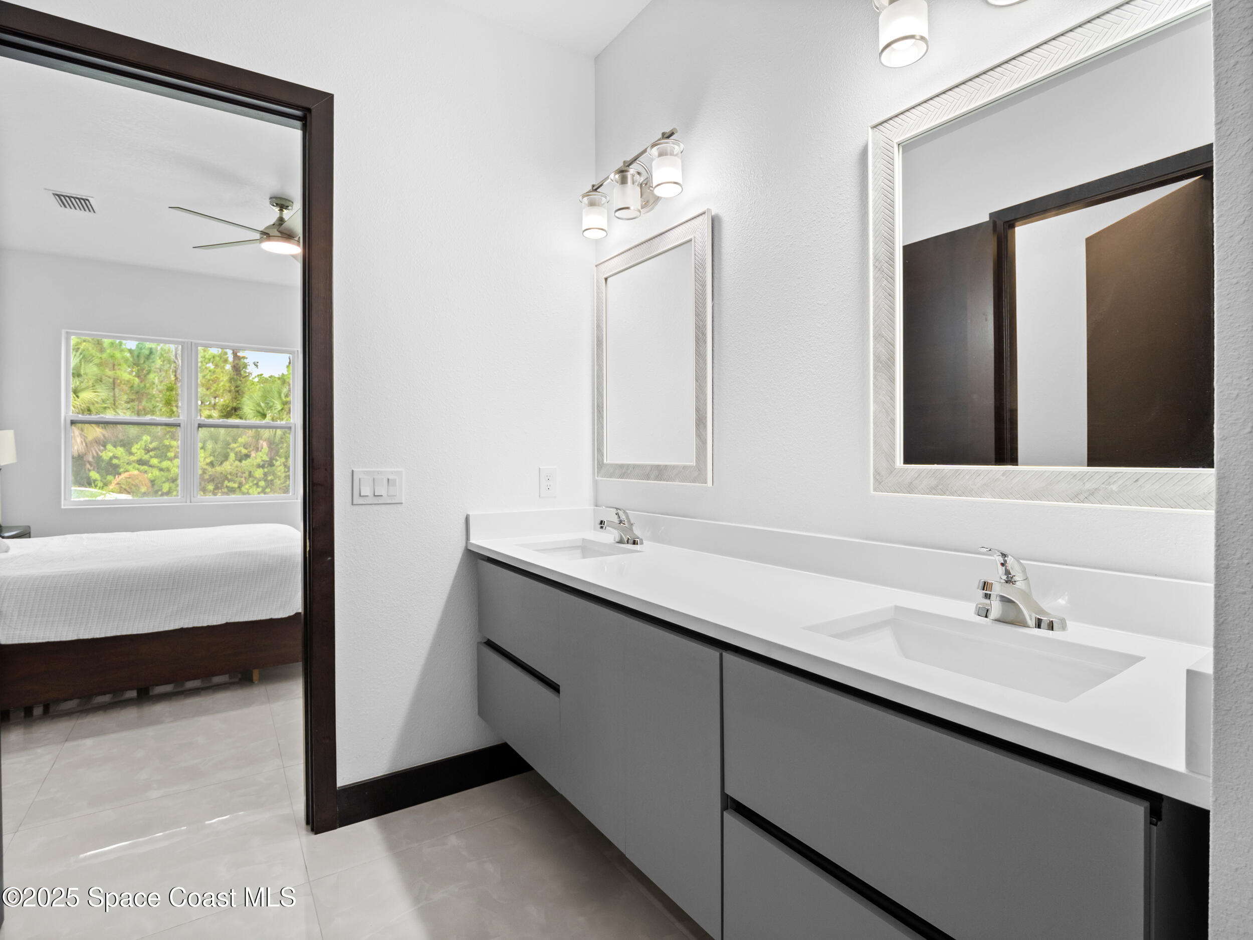 434 Flagler Road Southeast Palm Bay, FL 32909 - Photo 27 of 36 a bathroom with 2 sink and a mirror