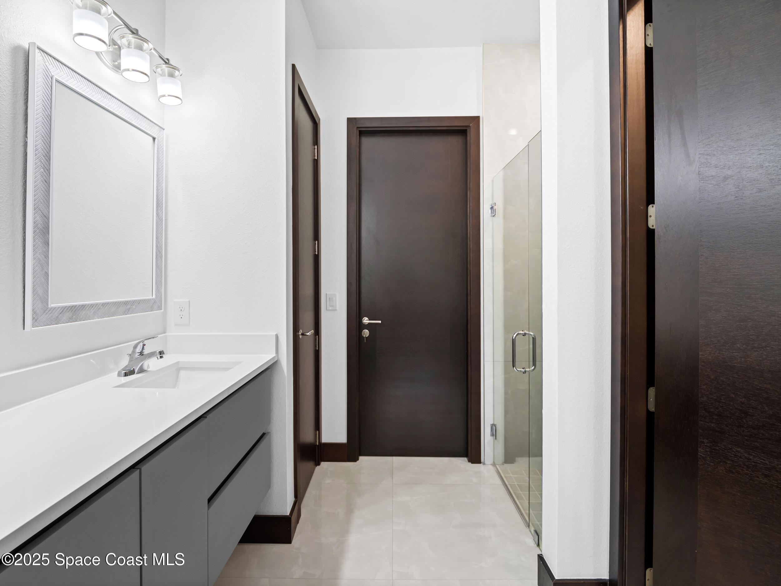 434 Flagler Road Southeast Palm Bay, FL 32909 - Photo 29 of 36 a en suite bathroom with a sink and a mirror