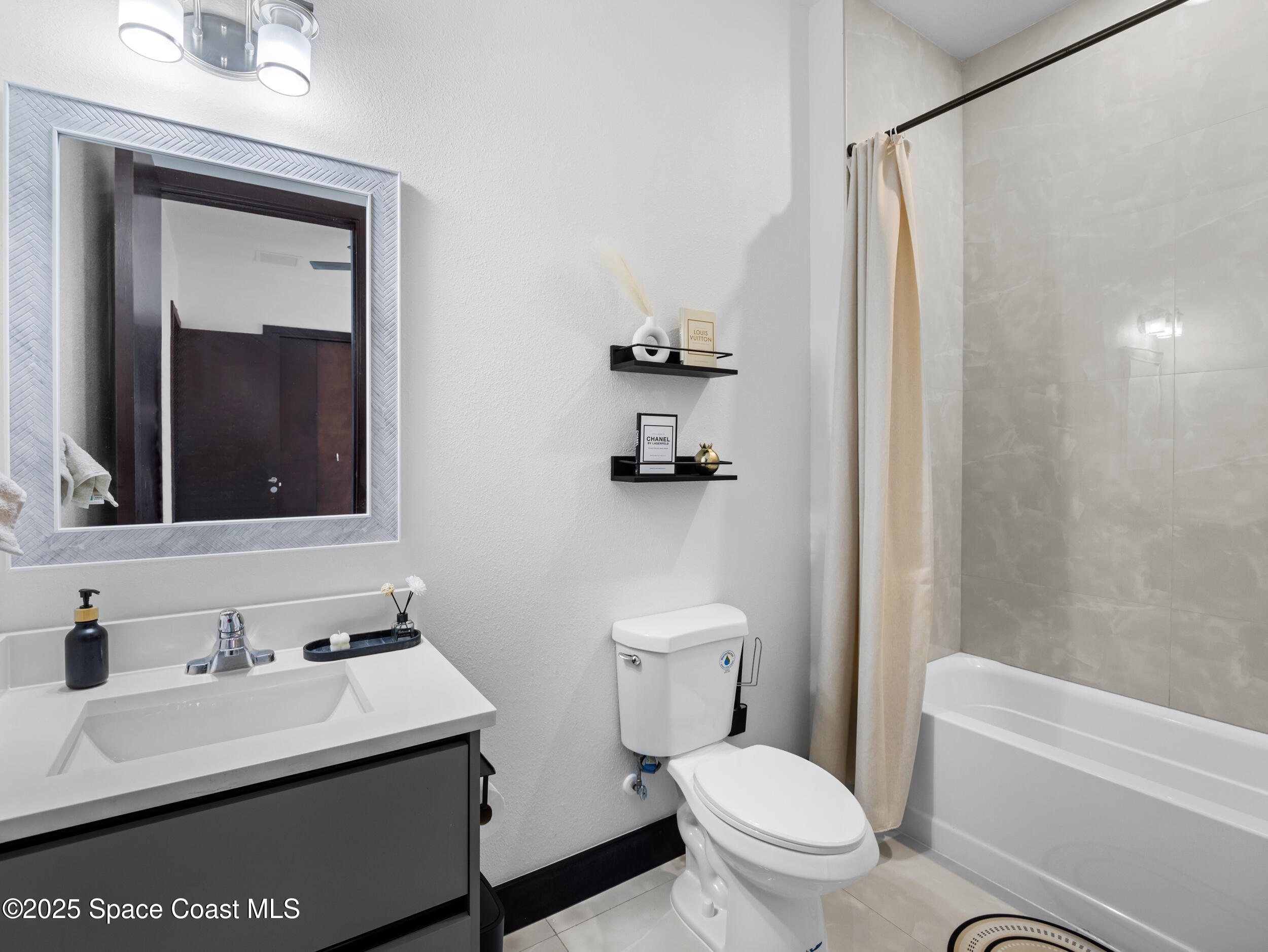 434 Flagler Road Southeast Palm Bay, FL 32909 - Photo 30 of 36 a bathroom with a sink toilet and mirror