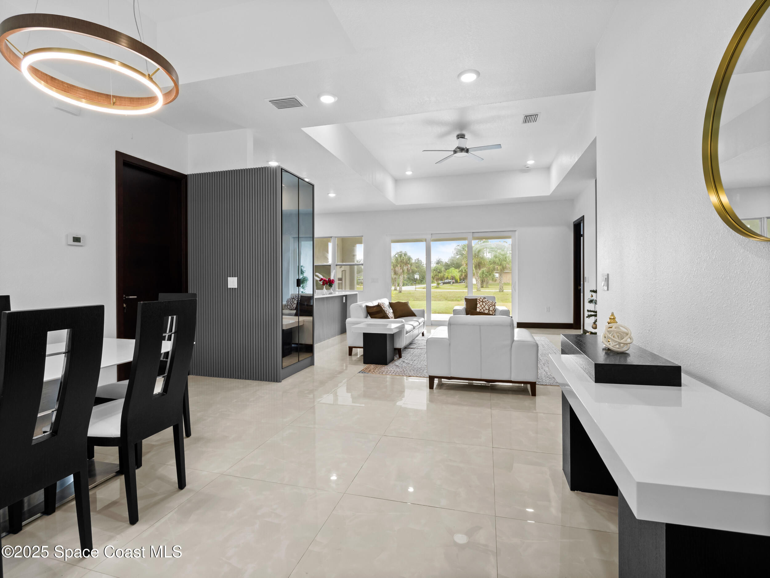 434 Flagler Road Southeast Palm Bay, FL 32909 - Photo 3 of 36 a living room with furniture a rug and white walls