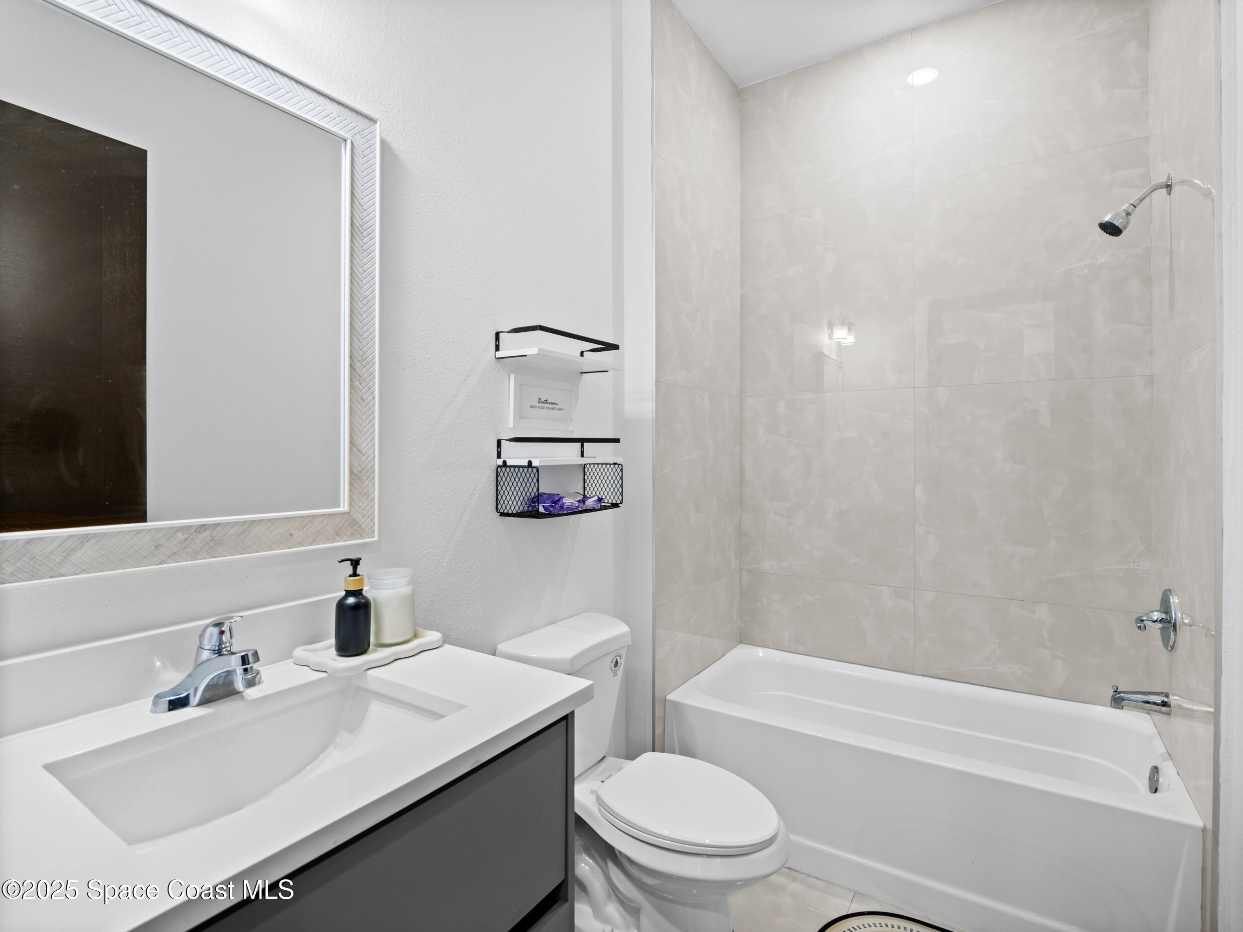 434 Flagler Road Southeast Palm Bay, FL 32909 - Photo 31 of 36 a bathroom with a sink toilet tub and shower