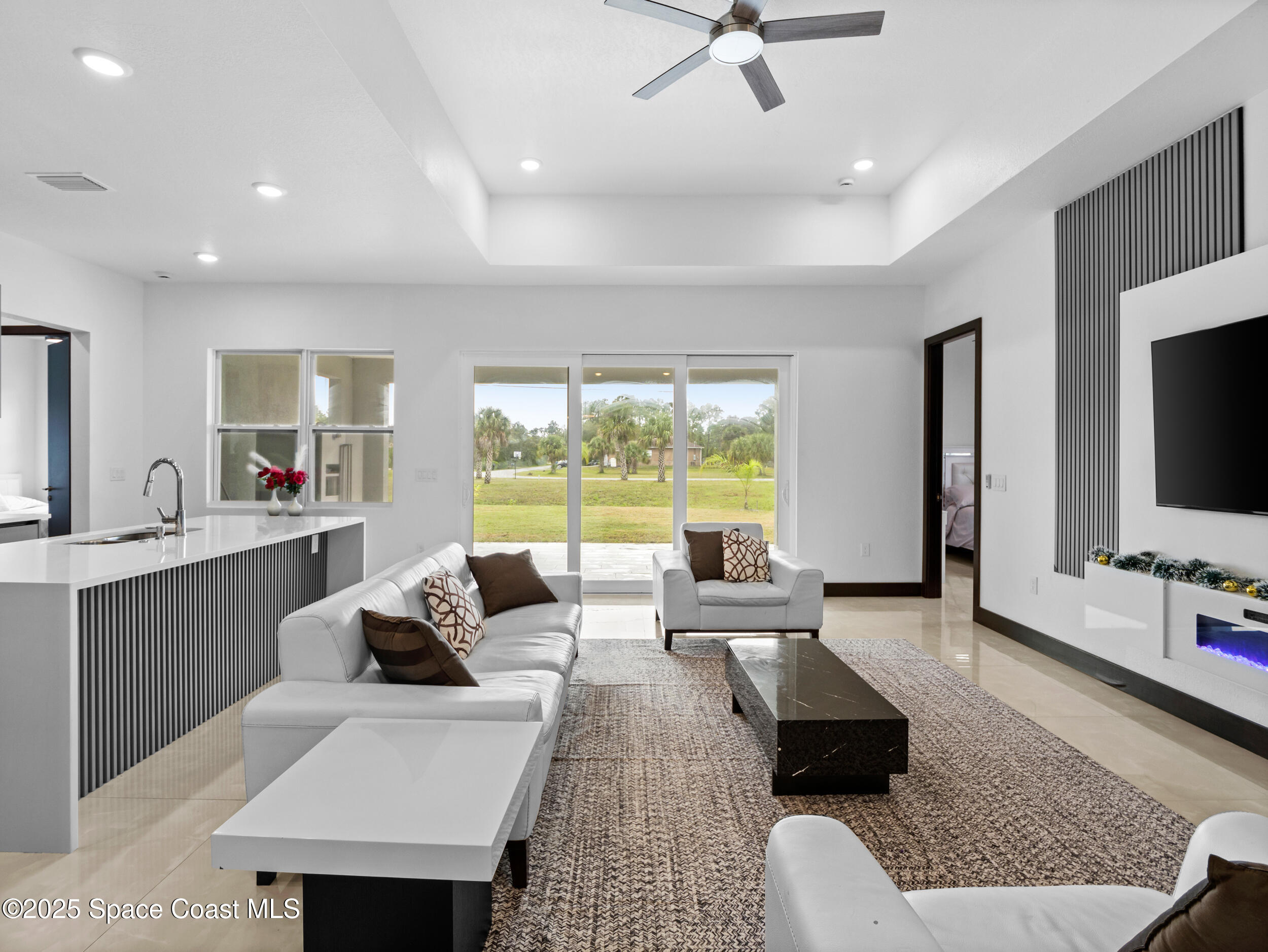 434 Flagler Road Southeast Palm Bay, FL 32909 - Photo 6 of 36 a living room with furniture and a flat screen tv