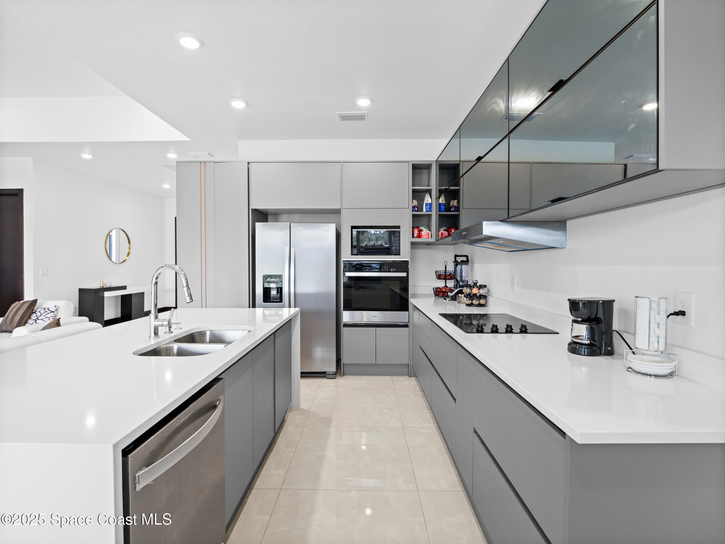 434 Flagler Road Southeast Palm Bay, FL 32909 - Photo 8 of 36 a large kitchen with stainless steel appliances kitchen island granite countertop a sink and cabinets