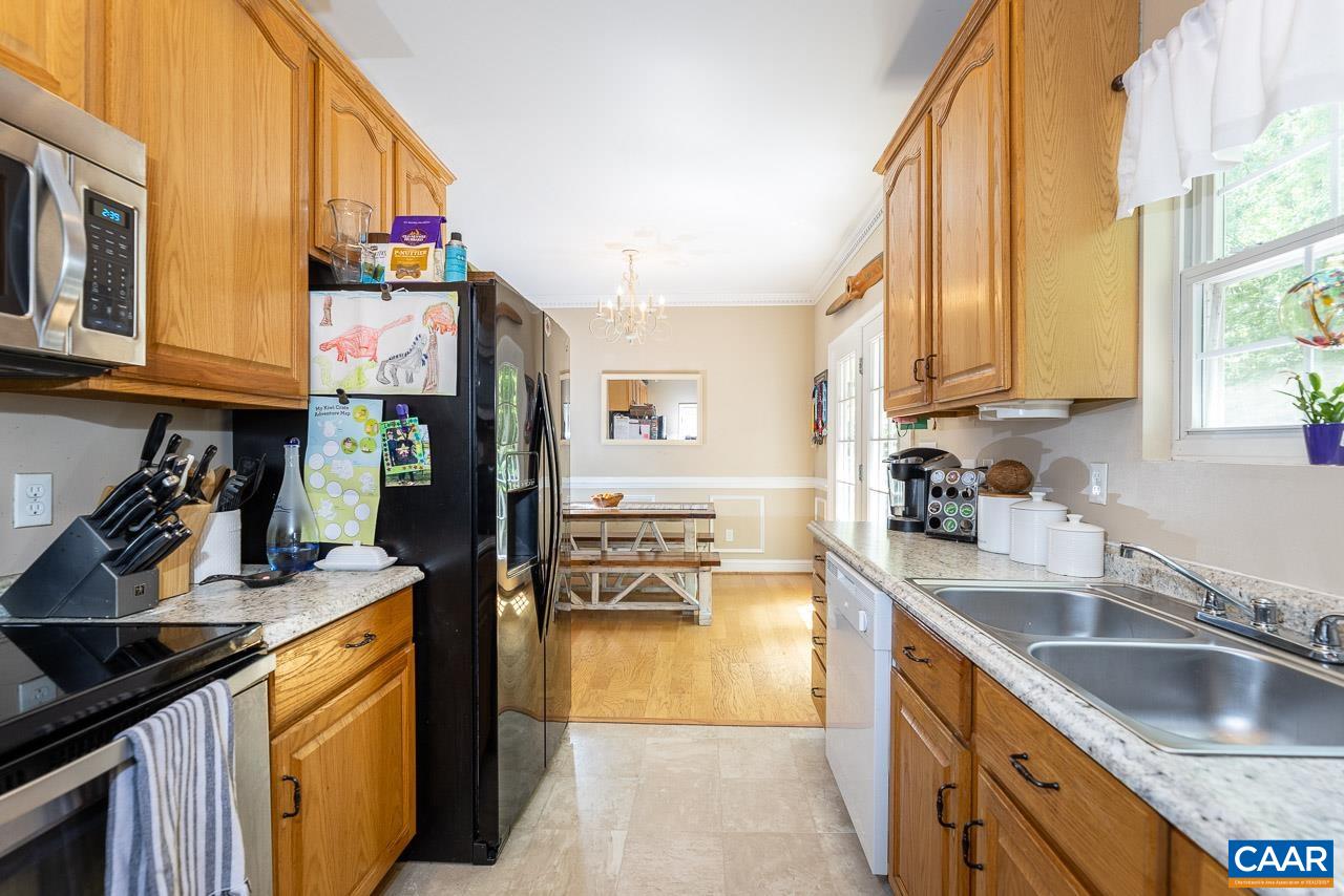 5 Tanglewood Road Palmyra, VA 22963 - Photo 5 of 17 a kitchen with stainless steel appliances granite countertop a sink stove and refrigerator