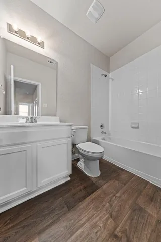 a bathroom with a sink toilet a mirror and vanity