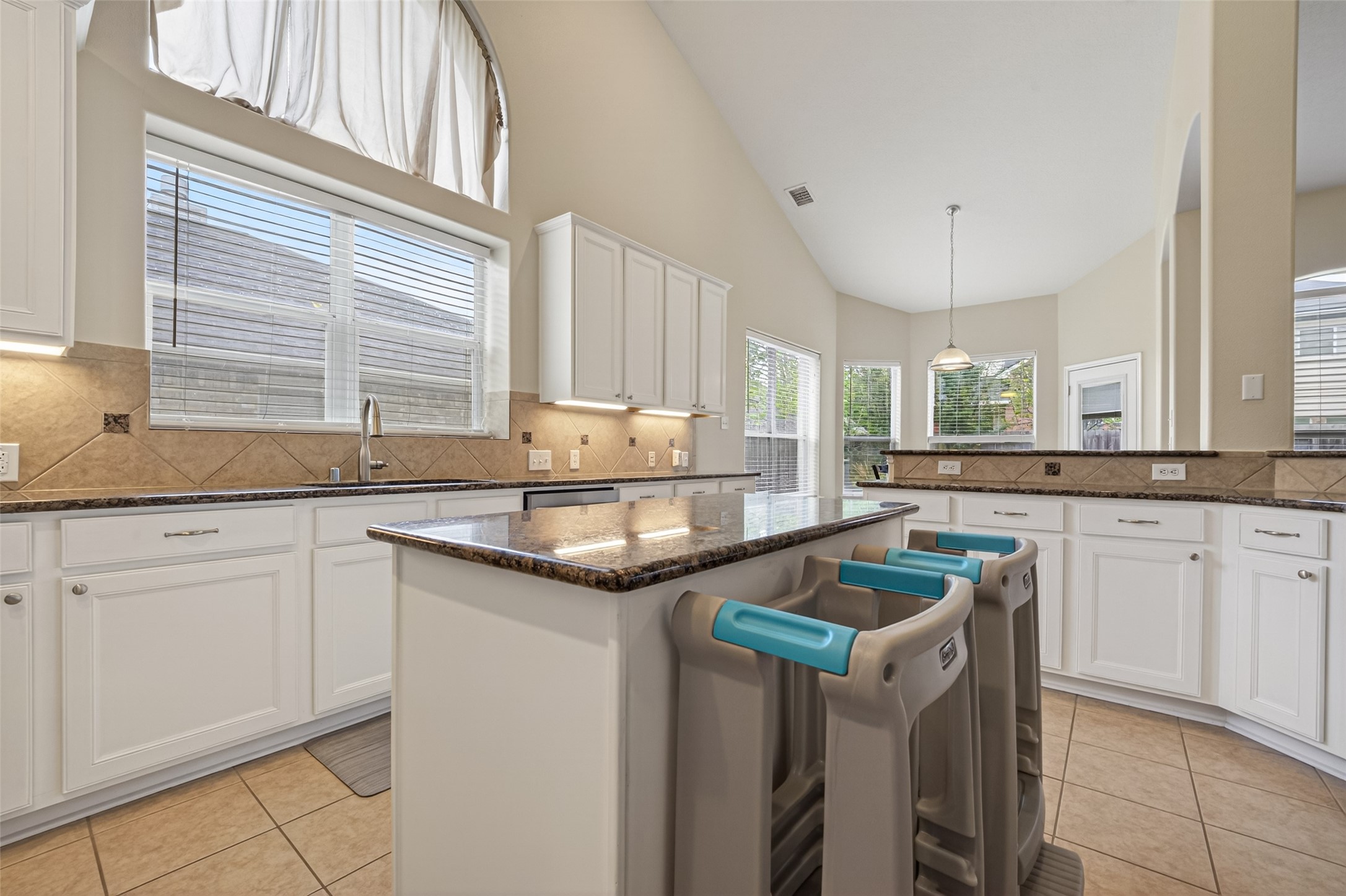 3219 Legends Mist Drive Spring, TX 77386 - Photo 17 of 37 a kitchen with granite countertop a sink and white cabinets