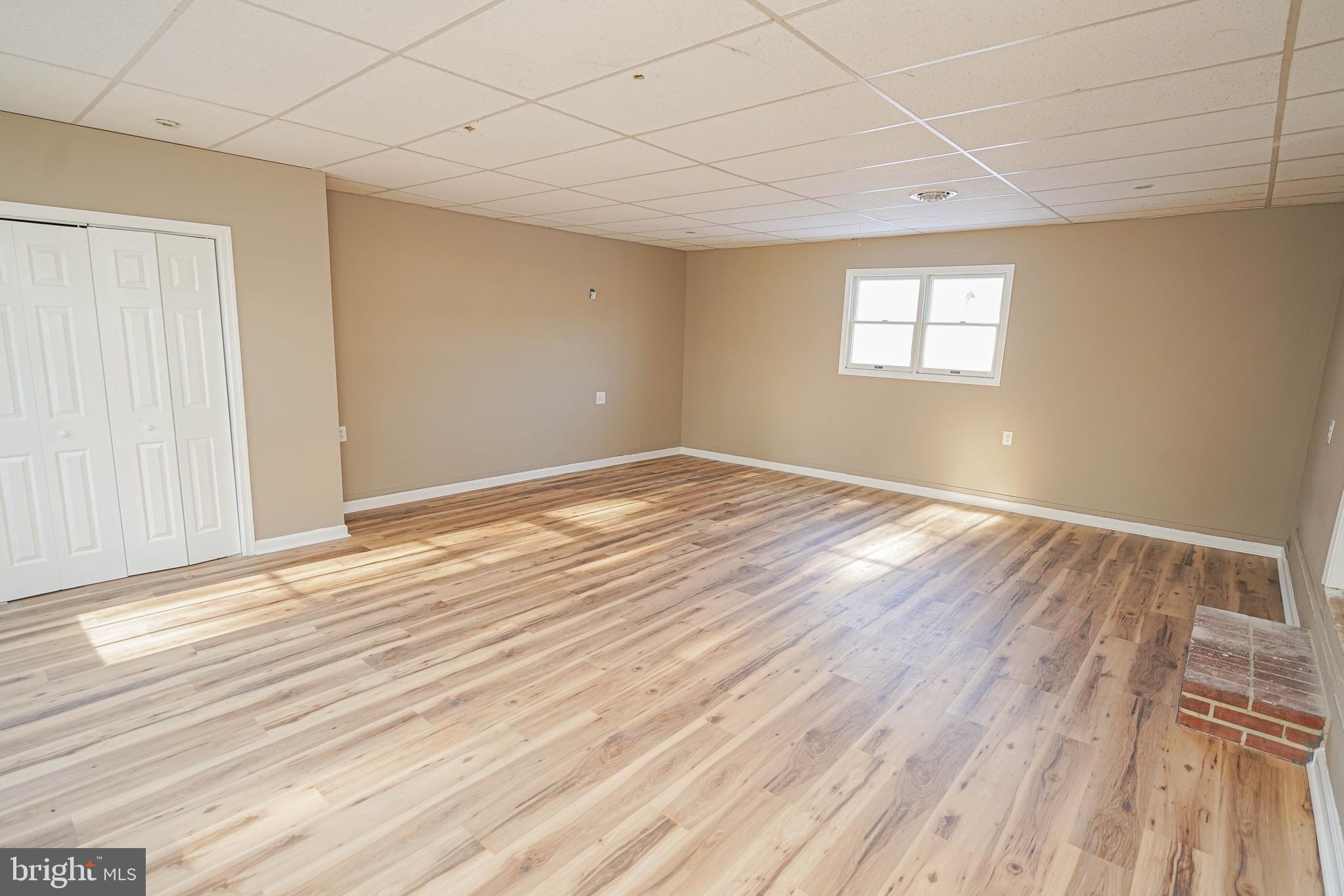 508 Race Street Vienna, MD 21869 - Photo 14 of 31 a view of an empty room with wooden floor and a window