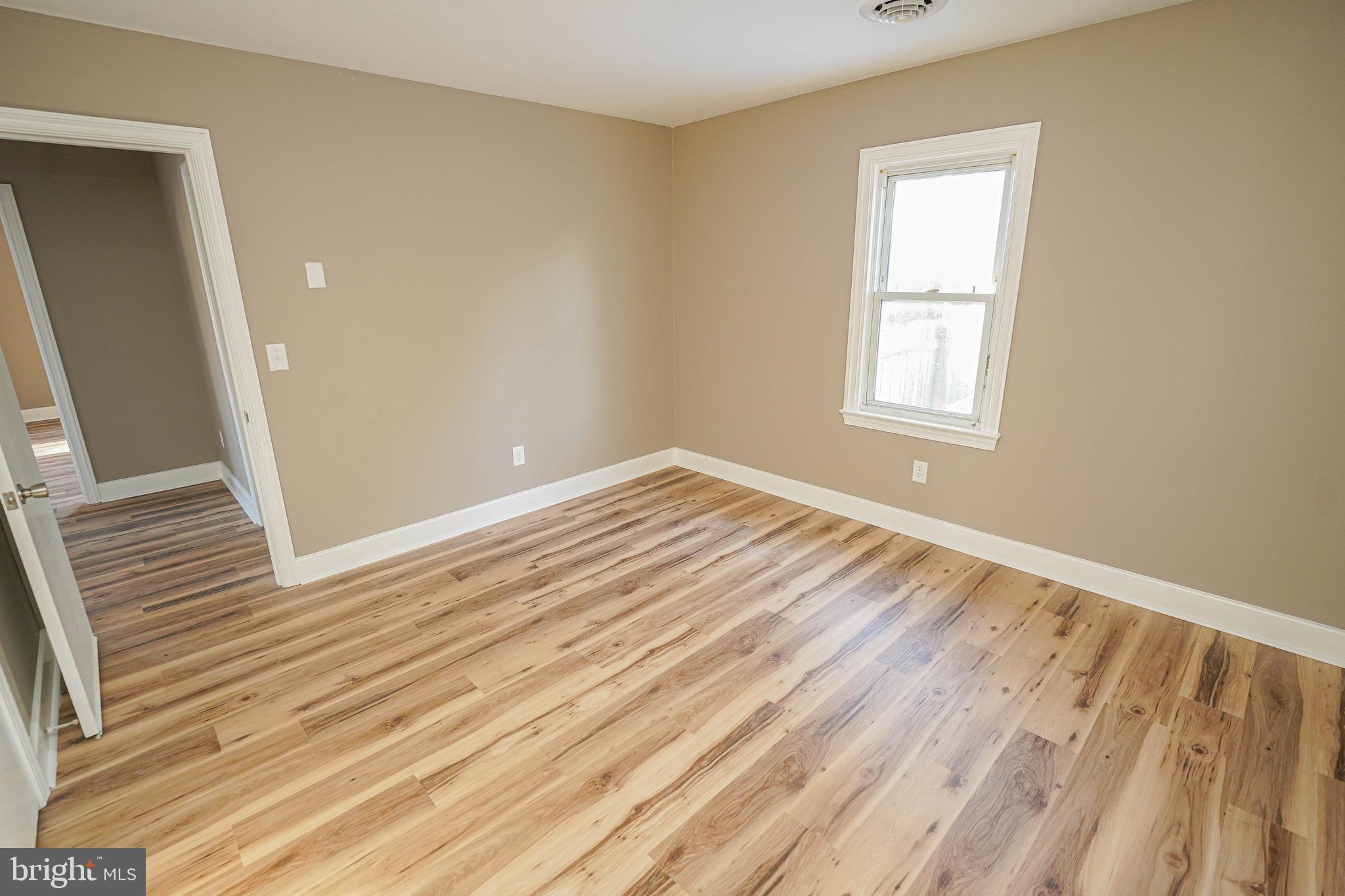 508 Race Street Vienna, MD 21869 - Photo 26 of 31 a view of an empty room with wooden floor and a window