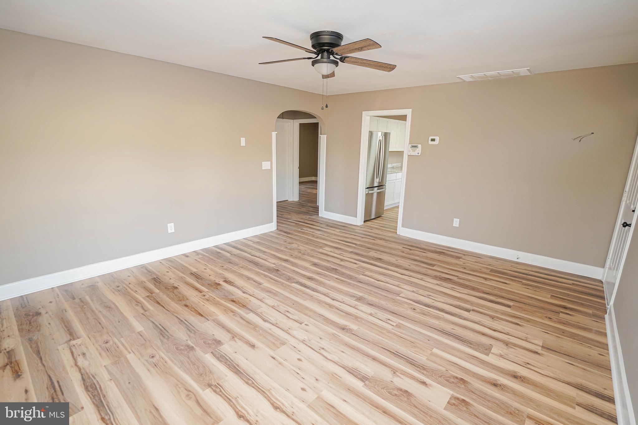 508 Race Street Vienna, MD 21869 - Photo 5 of 31 a view of a room with wooden floor and ceiling fan