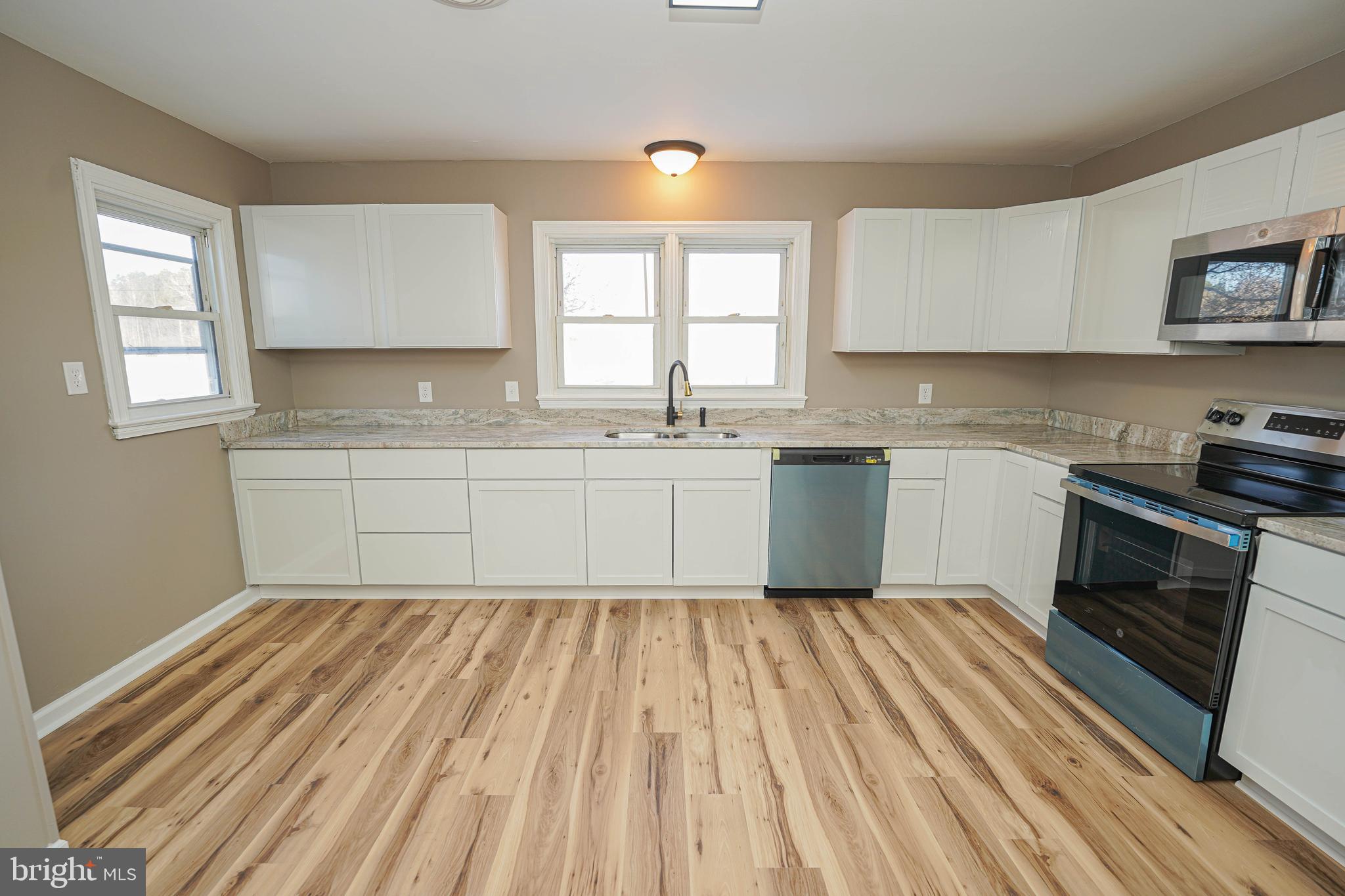 508 Race Street Vienna, MD 21869 - Photo 9 of 31 a kitchen with a sink stove and cabinets