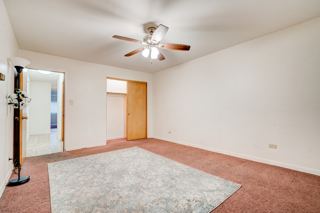 6905 Cermak Road Berwyn, IL 60402 - Photo 11 of 29 an empty room with closet and a chandelier fan