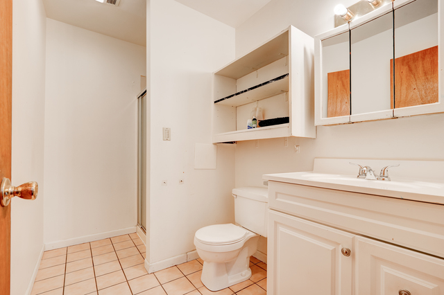 6905 Cermak Road Berwyn, IL 60402 - Photo 12 of 29 a bathroom with a sink a toilet and mirror