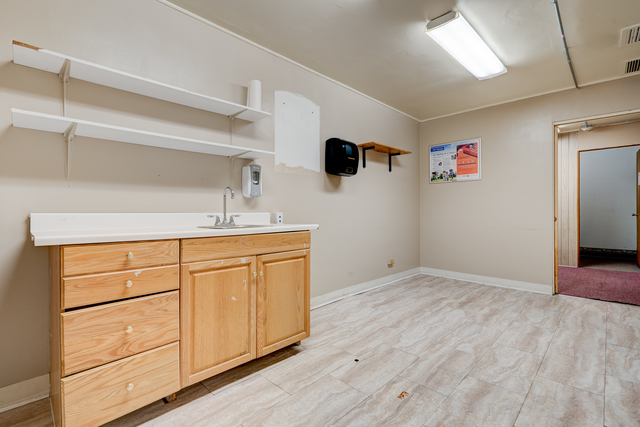 6905 Cermak Road Berwyn, IL 60402 - Photo 19 of 29 a kitchen with a sink cabinets and a wooden floor