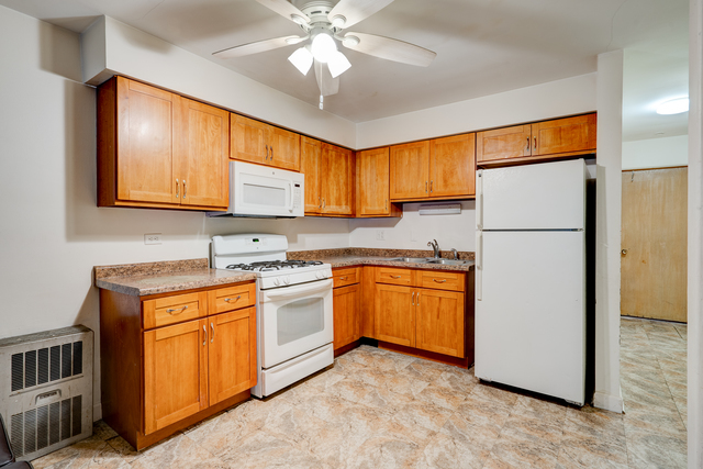 6905 Cermak Road Berwyn, IL 60402 - Photo 9 of 29 a kitchen with stainless steel appliances granite countertop a refrigerator a sink dishwasher a stove top oven a refrigerator and cabinets