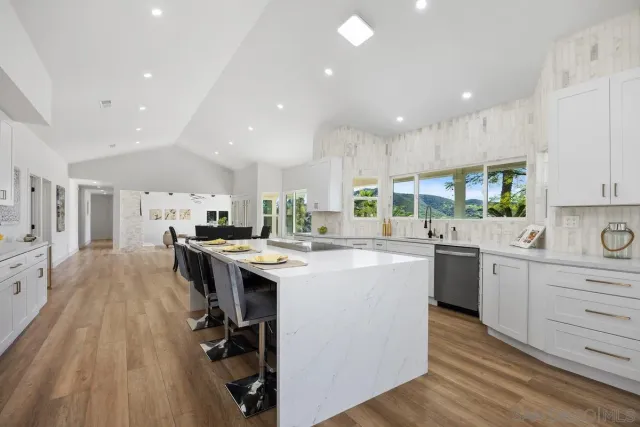 a view of living room filled with furniture and floor to ceiling window