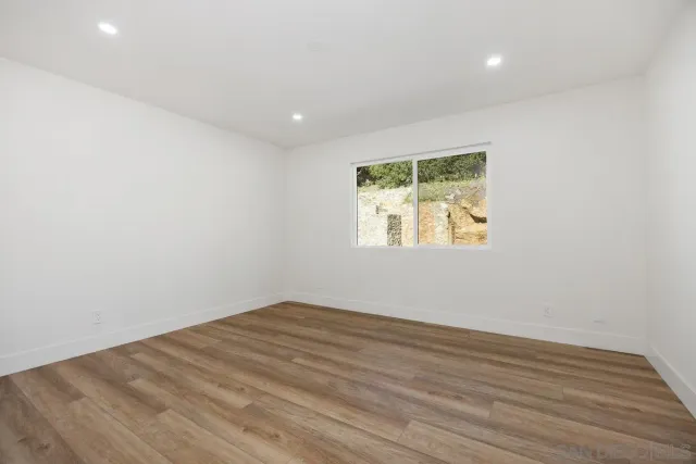 a workspace with furniture a fireplace and wooden floor