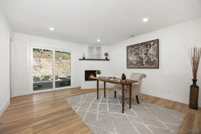 a view of a patio with couches and a fireplace