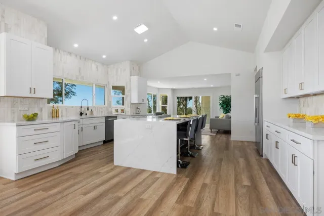 a kitchen with a sink and a large window