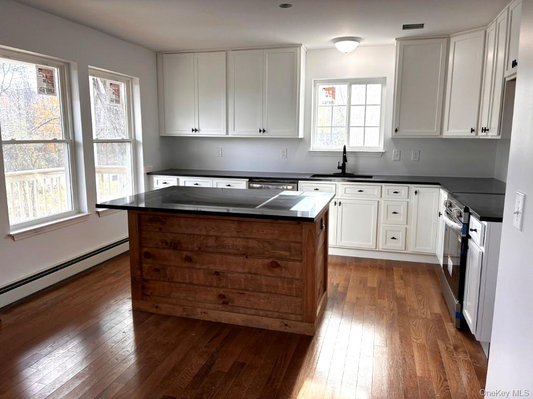 458 County Route 50 New Hampton, NY 10958 - Photo 2 of 35 a kitchen with granite countertop wooden cabinets a sink a window and appliances