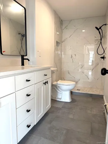 a bathroom with a toilet and a shower view