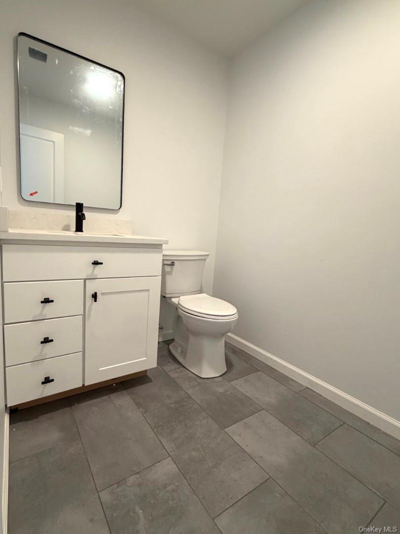 458 County Route 50 New Hampton, NY 10958 - Photo 6 of 35 Half bathroom with vanity and dark tile patterned floors