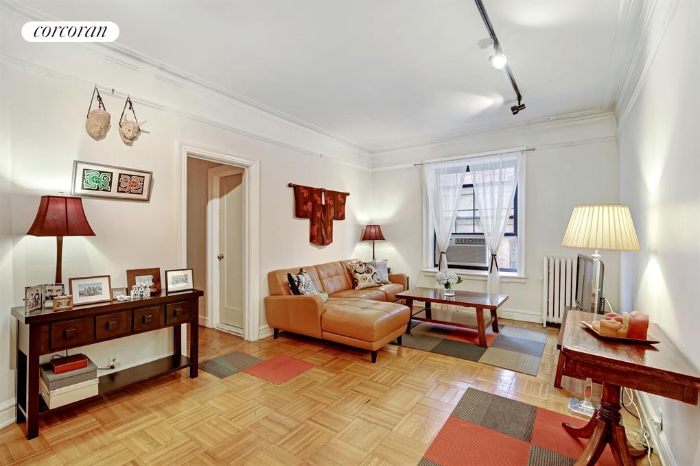 a living room with furniture and a lamp