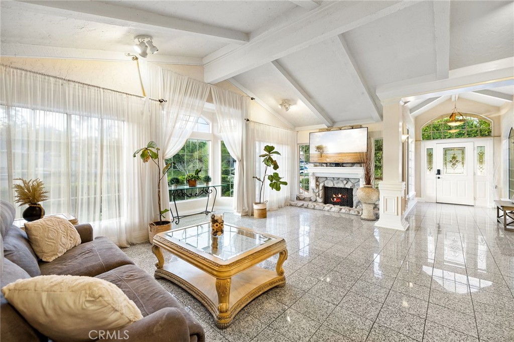 242 Summit Road La Verne, CA 91750 - Photo 9 of 75 a living room with furniture a fireplace and a large window with garden view