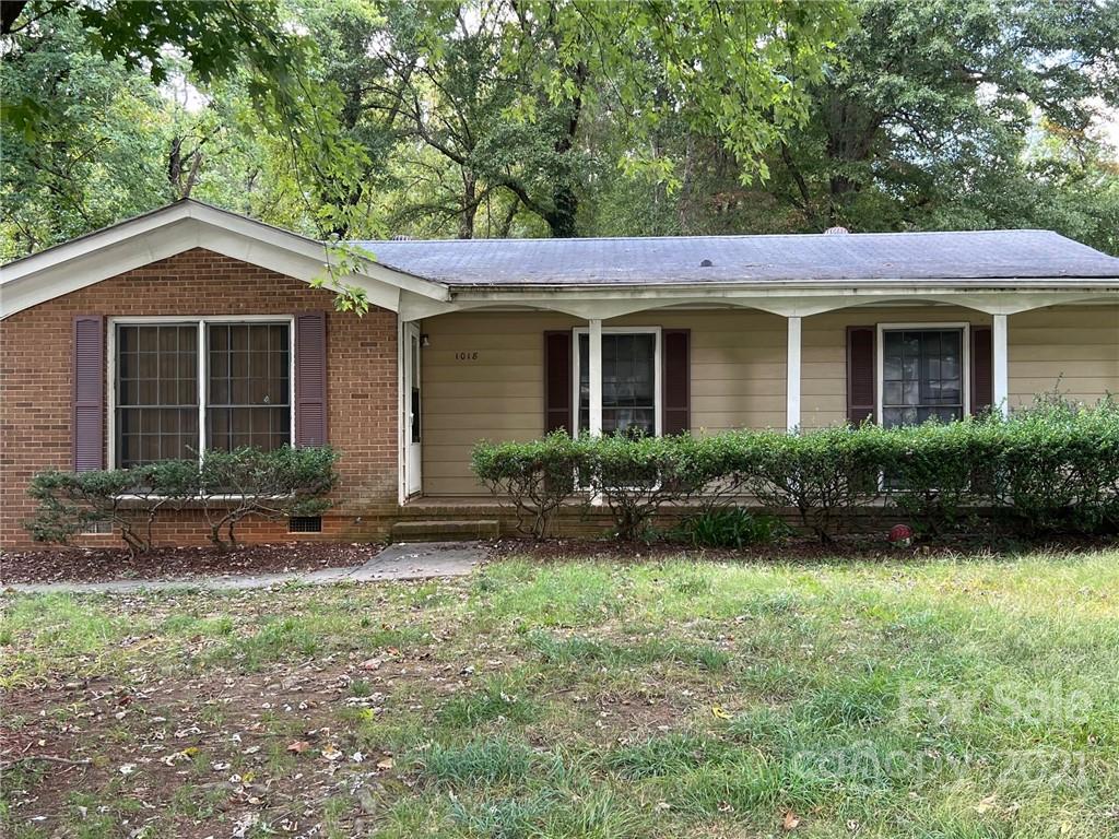 1018 Tilden Road Charlotte, NC 28214 - Photo 2 of 17 a view of a yard in front of a house with plants and large tree