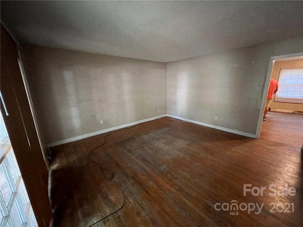 1018 Tilden Road Charlotte, NC 28214 - Photo 5 of 17 an empty room with wooden floor