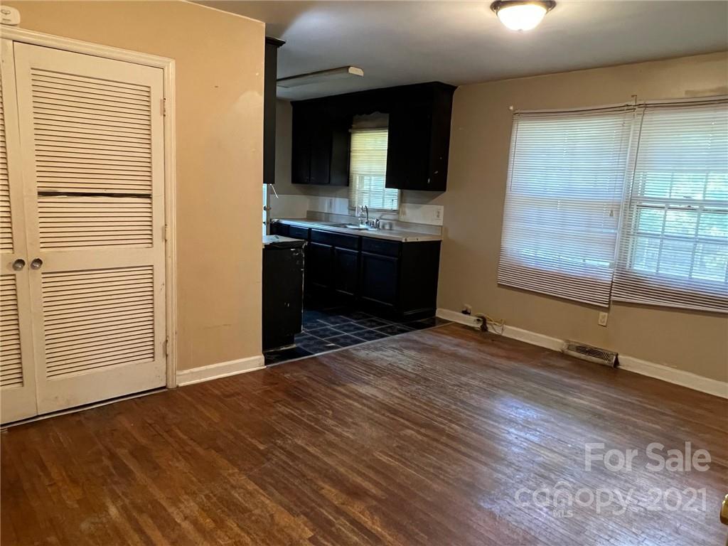 1018 Tilden Road Charlotte, NC 28214 - Photo 7 of 17 an empty room with wooden floor and windows