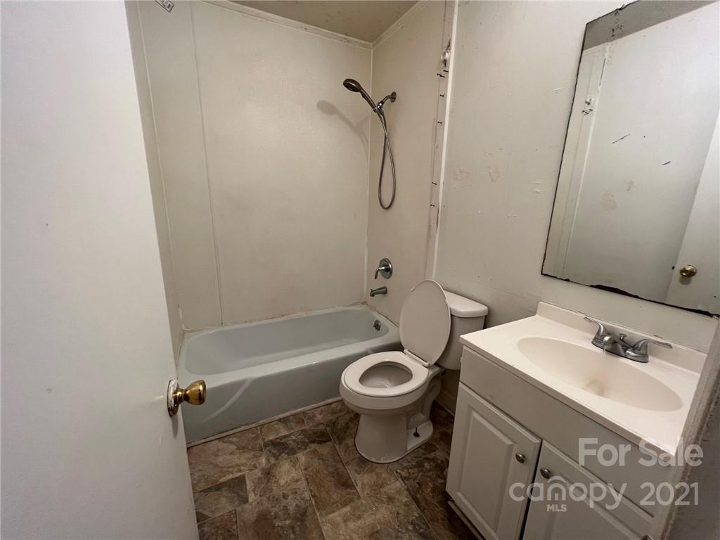 1018 Tilden Road Charlotte, NC 28214 - Photo 9 of 17 a bathroom with a sink toilet and shower