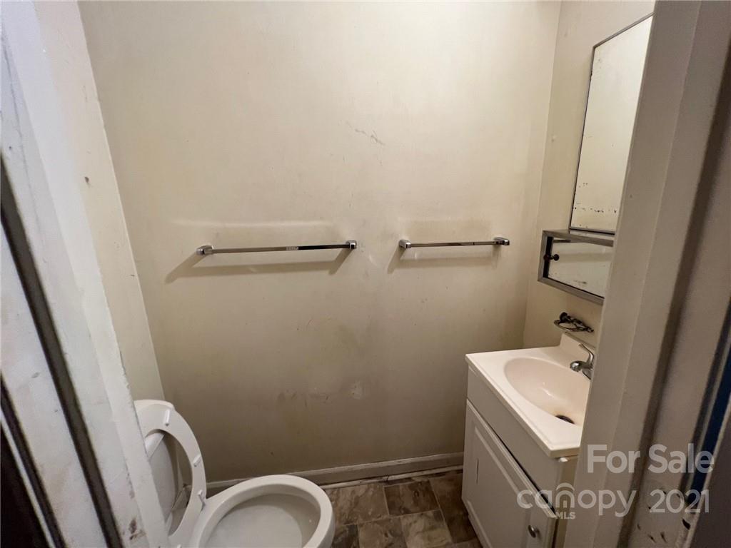 1018 Tilden Road Charlotte, NC 28214 - Photo 10 of 17 a bathroom with a sink and mirror with toilet