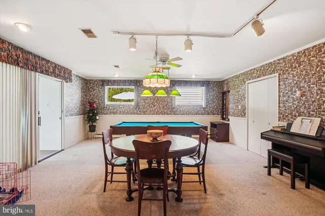 a dining room with furniture and window