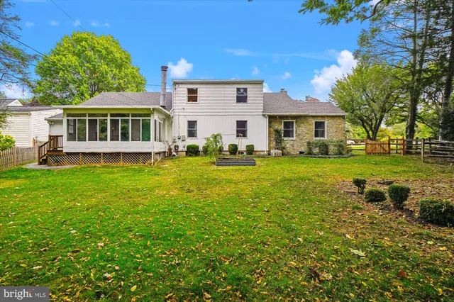 a front view of a house with a yard table and chairs