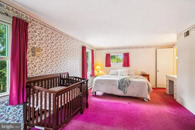 a spacious bedroom with a bed and a window