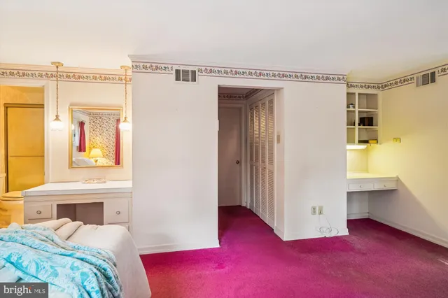 a bedroom with a bed and a view of en suite bathroom