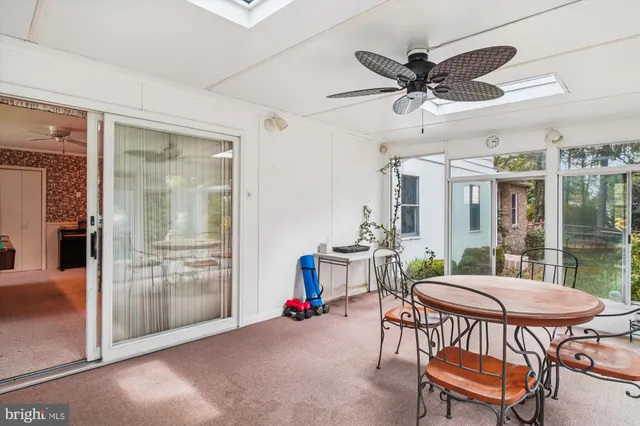 a view of a dining room with furniture and a chandelier