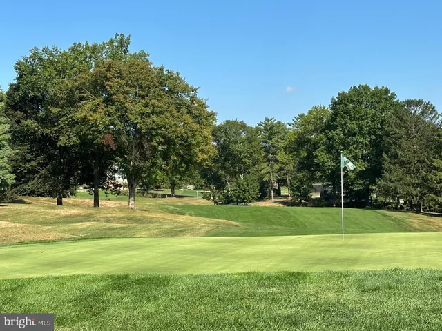 a view of swimming pool with an outdoor seating and yard