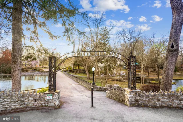 a view of a lake with a yard and large trees
