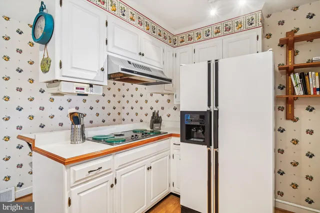 a kitchen with stainless steel appliances a refrigerator and a stove