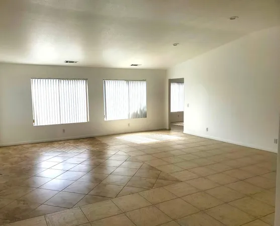 an empty room with windows and entrance