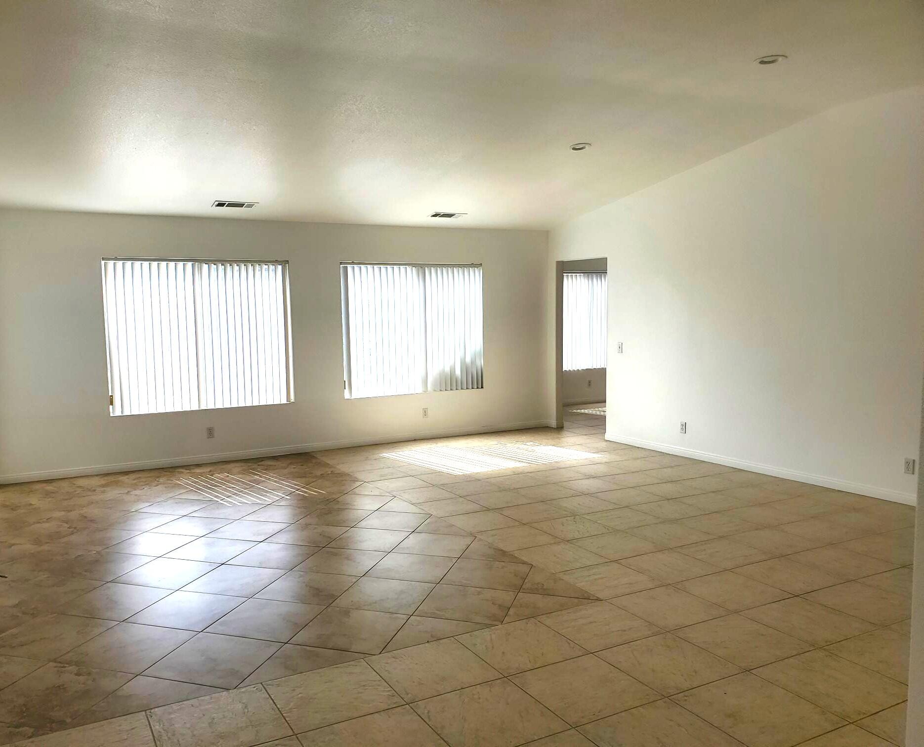 80625 Virginia Avenue Indio, CA 92201 - Photo 2 of 13 an empty room with windows and entrance