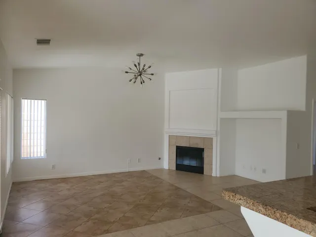 a view of an empty room with a fireplace