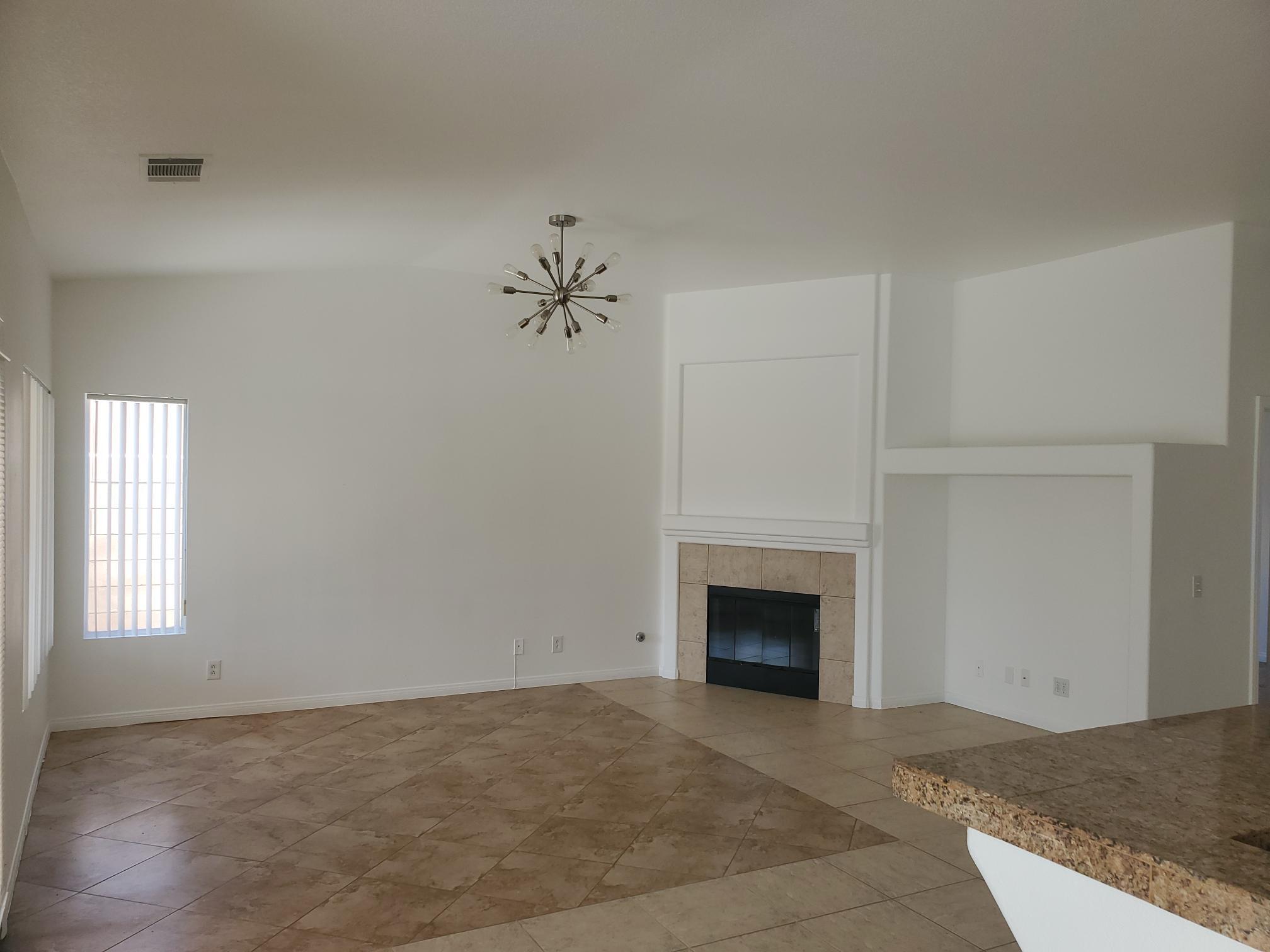 80625 Virginia Avenue Indio, CA 92201 - Photo 3 of 13 a view of an empty room with a fireplace